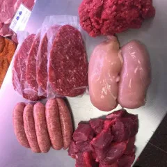 various raw meat on stainless steal counter top