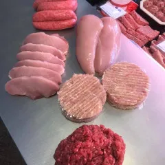 various raw meat on stainless steal counter top 2
